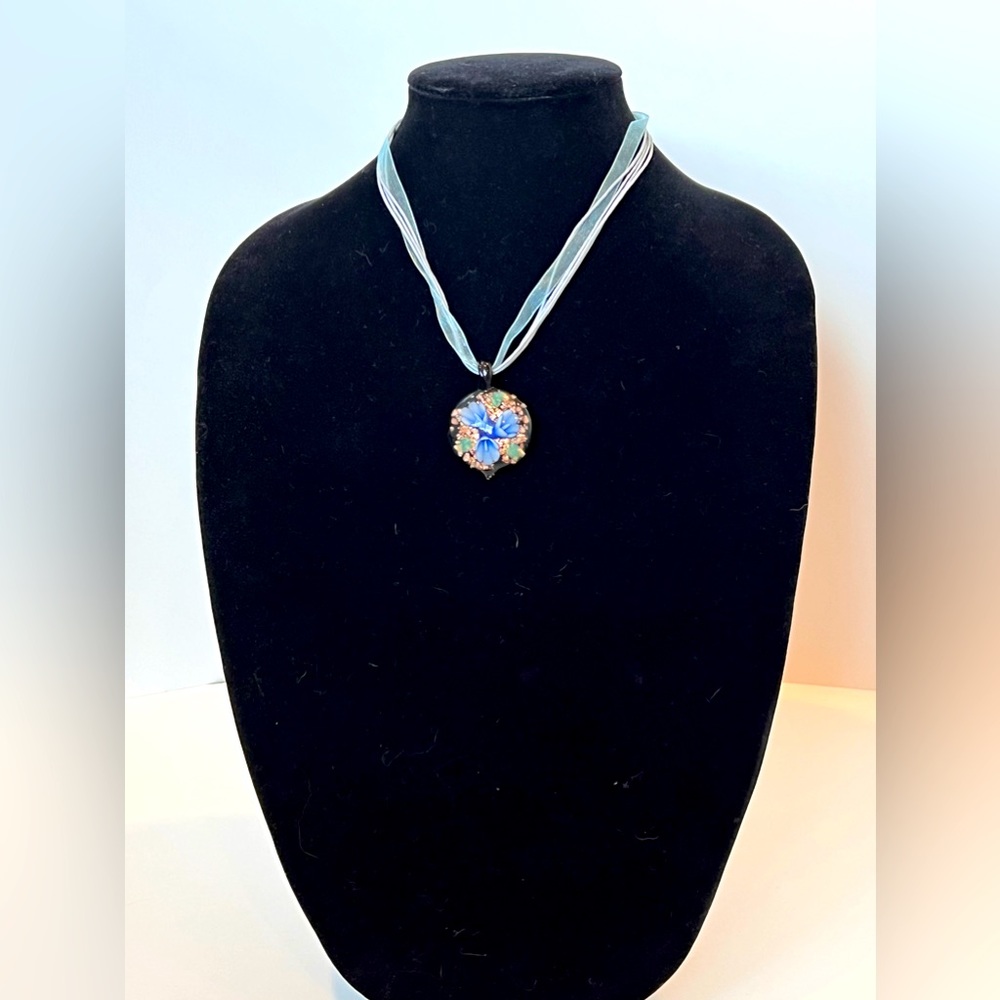 Vintage Glass Flower Pendant Necklace with Soft Blue Ribbon on Neck.